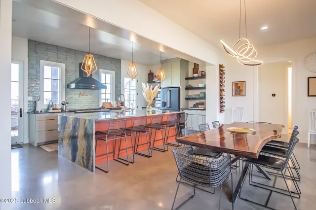 a kitchen with stainless steel appliances granite countertop a sink dishwasher and a stove with wooden floor