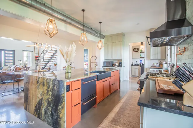 a kitchen with granite countertop white cabinets and a sink