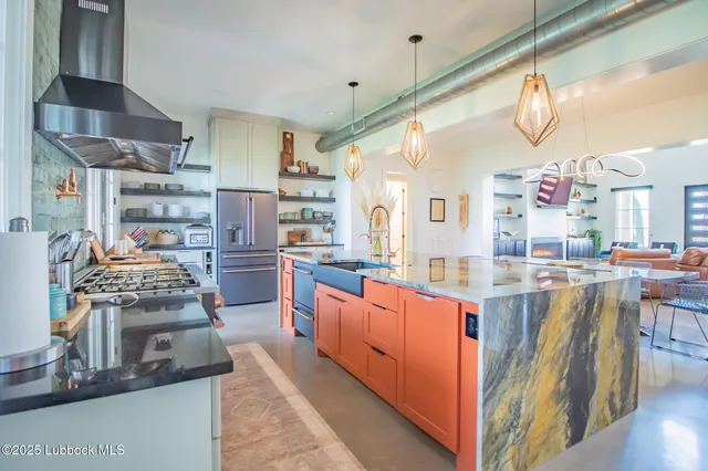 a kitchen with stainless steel appliances granite countertop a sink and cabinets
