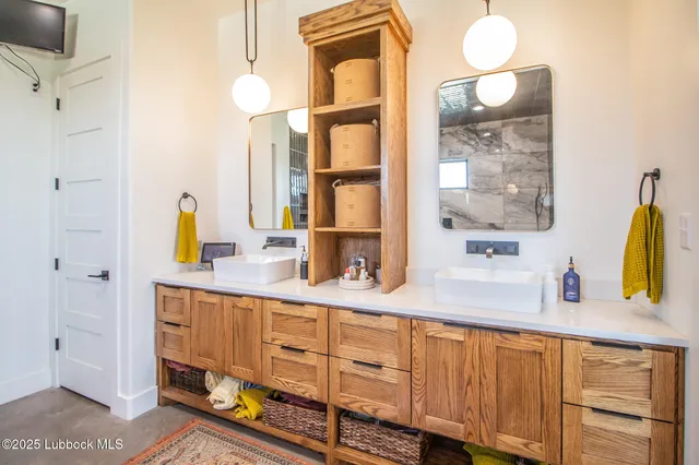 a bathroom with a sink and a mirror with toilet
