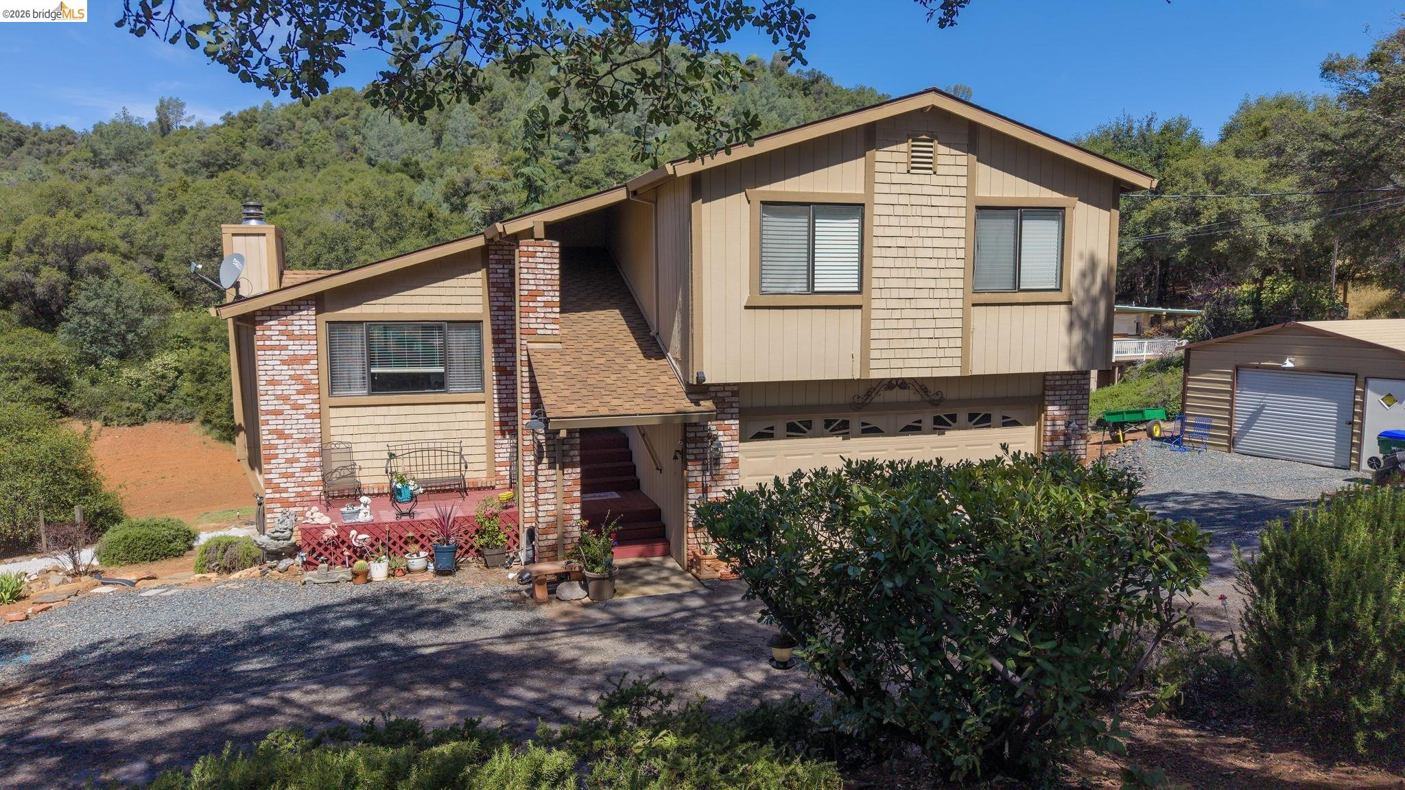 11858 Campo Seco Road Sonora, CA 95370 - Photo 4 of 45 Multi-level property featuring a two-car garage, an additional detached garage, and a brick-accented facade