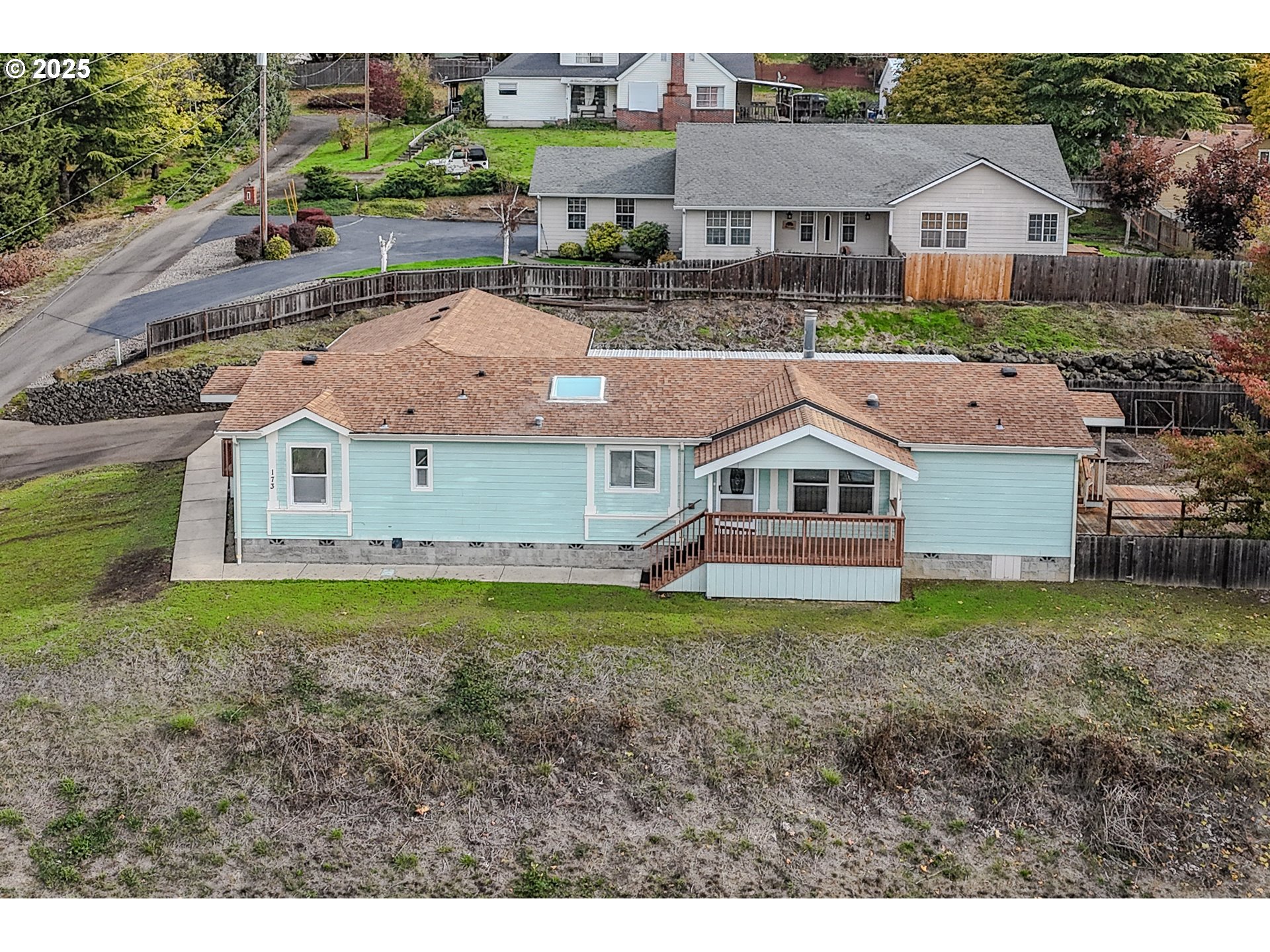 173 North Main Street Winston, OR 97496 - Photo 1 of 45 a aerial view of a house with a yard and large trees