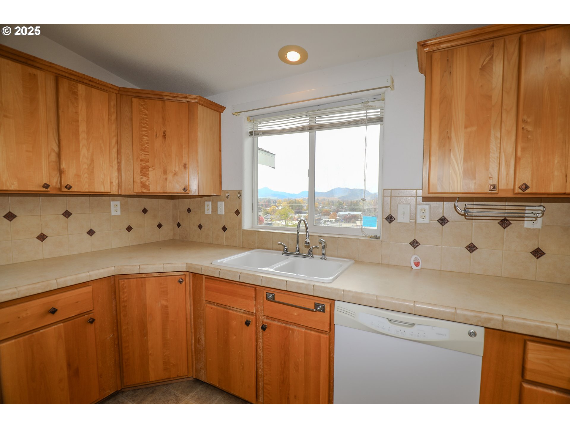 173 North Main Street Winston, OR 97496 - Photo 12 of 45 a kitchen with granite countertop a sink window and cabinets