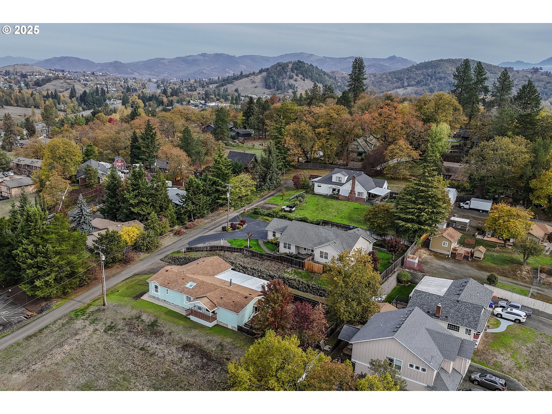 173 North Main Street Winston, OR 97496 - Photo 2 of 45 an aerial view of residential house with outdoor space and mountain view