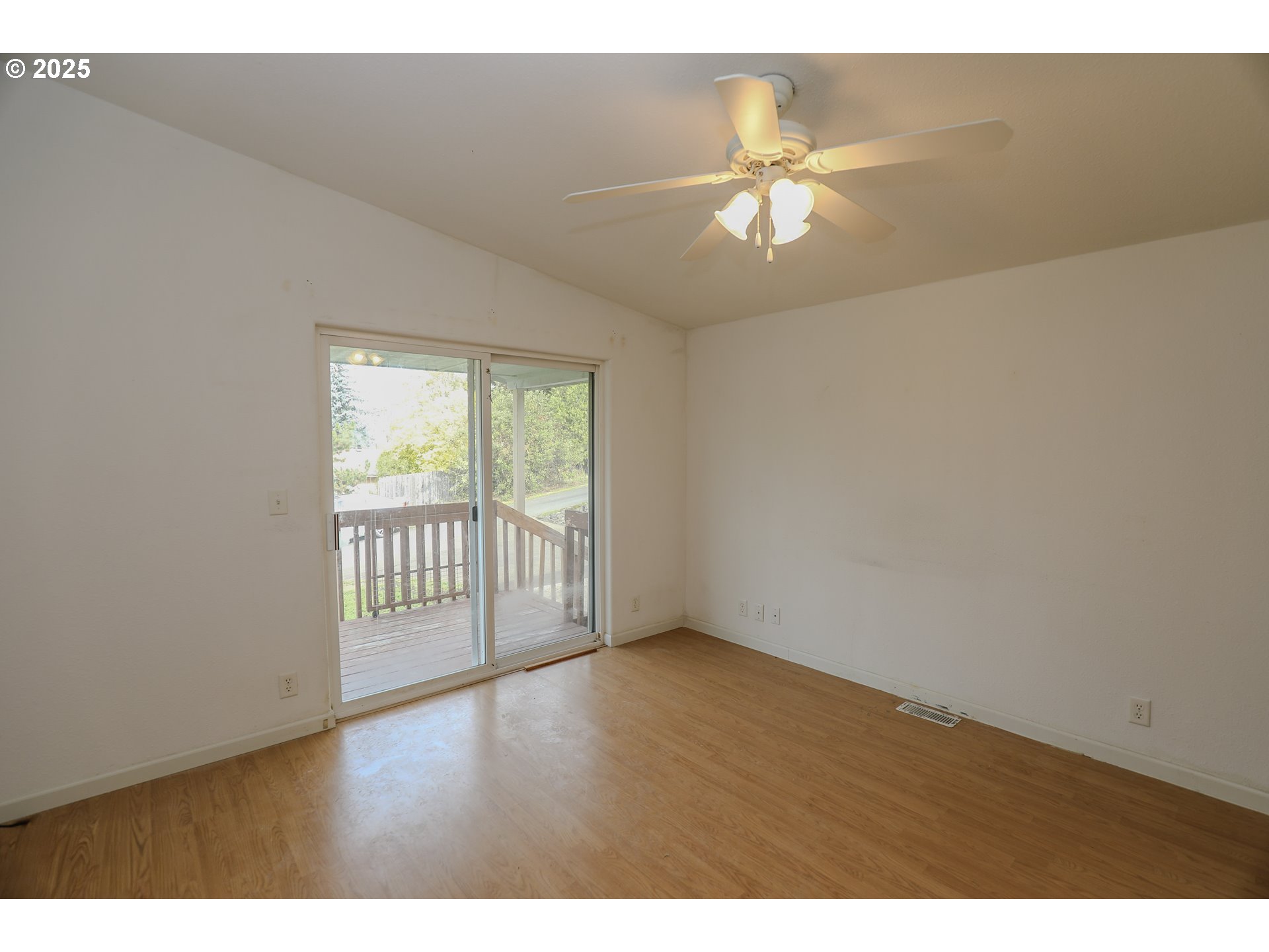 173 North Main Street Winston, OR 97496 - Photo 21 of 45 a view of an empty room with wooden floor and a window