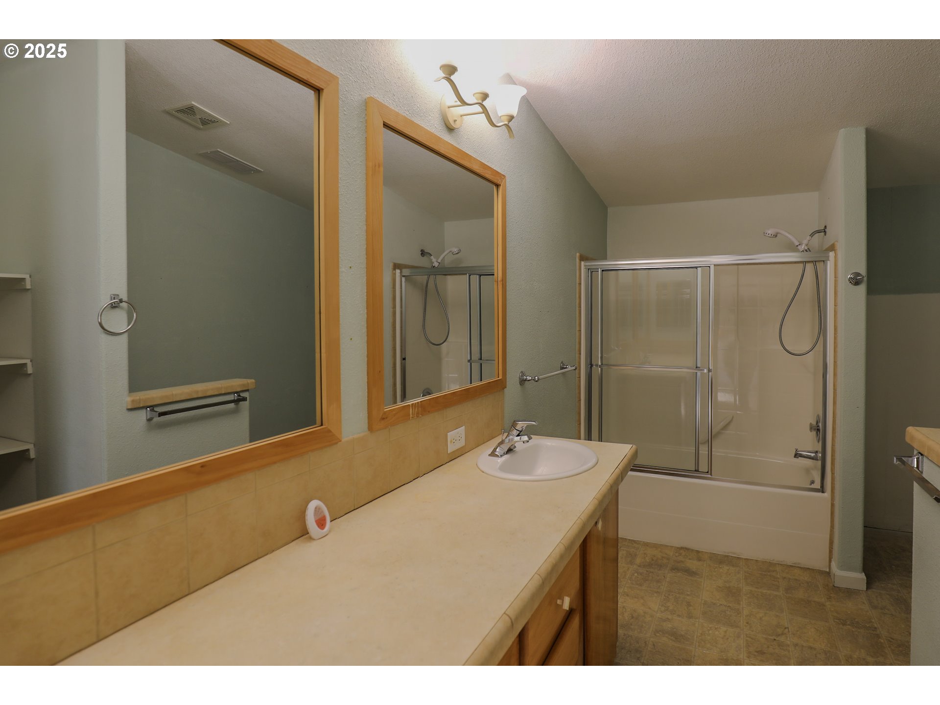173 North Main Street Winston, OR 97496 - Photo 23 of 45 a bathroom with a sink mirror and a shower