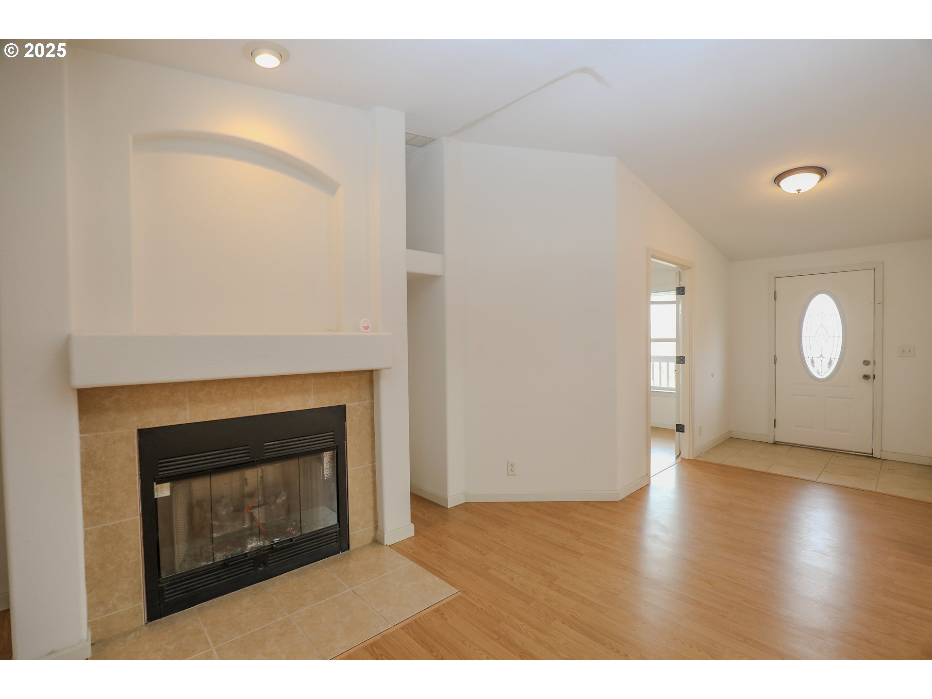 173 North Main Street Winston, OR 97496 - Photo 5 of 45 a view of an empty room with wooden floor and a fireplace