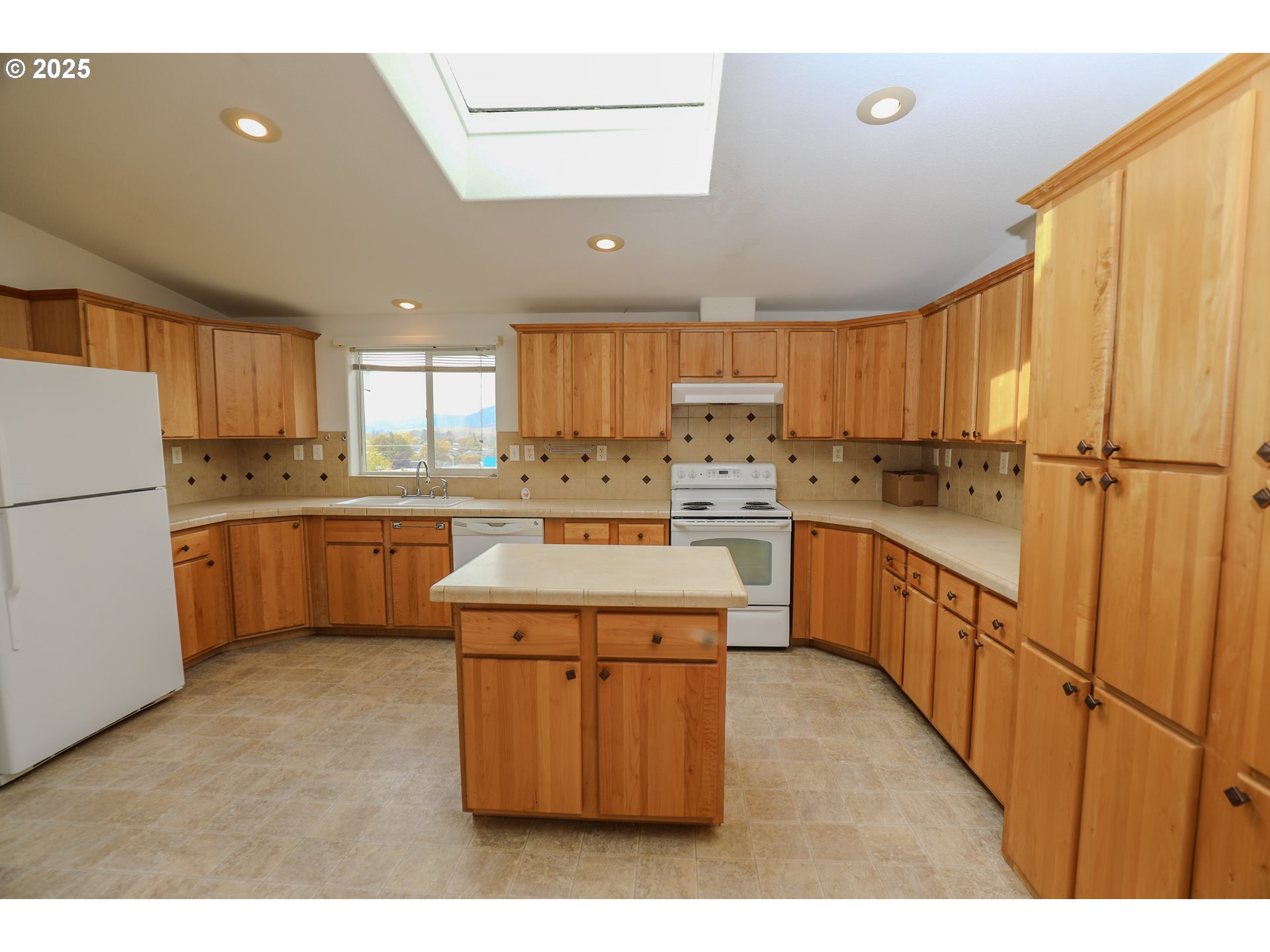 173 North Main Street Winston, OR 97496 - Photo 9 of 45 a kitchen with a sink refrigerator and cabinets