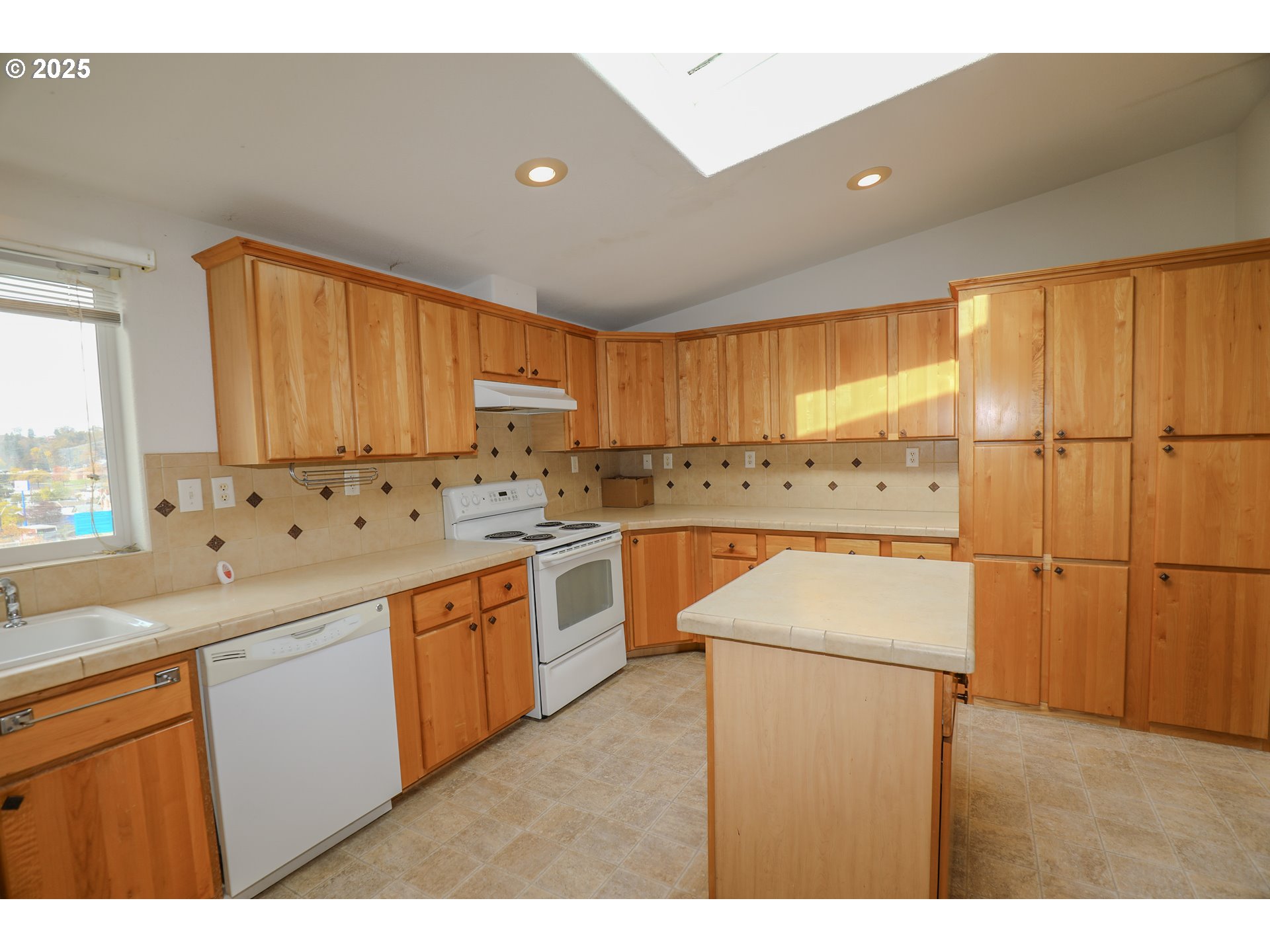 173 North Main Street Winston, OR 97496 - Photo 10 of 45 a kitchen with a sink a window and cabinets