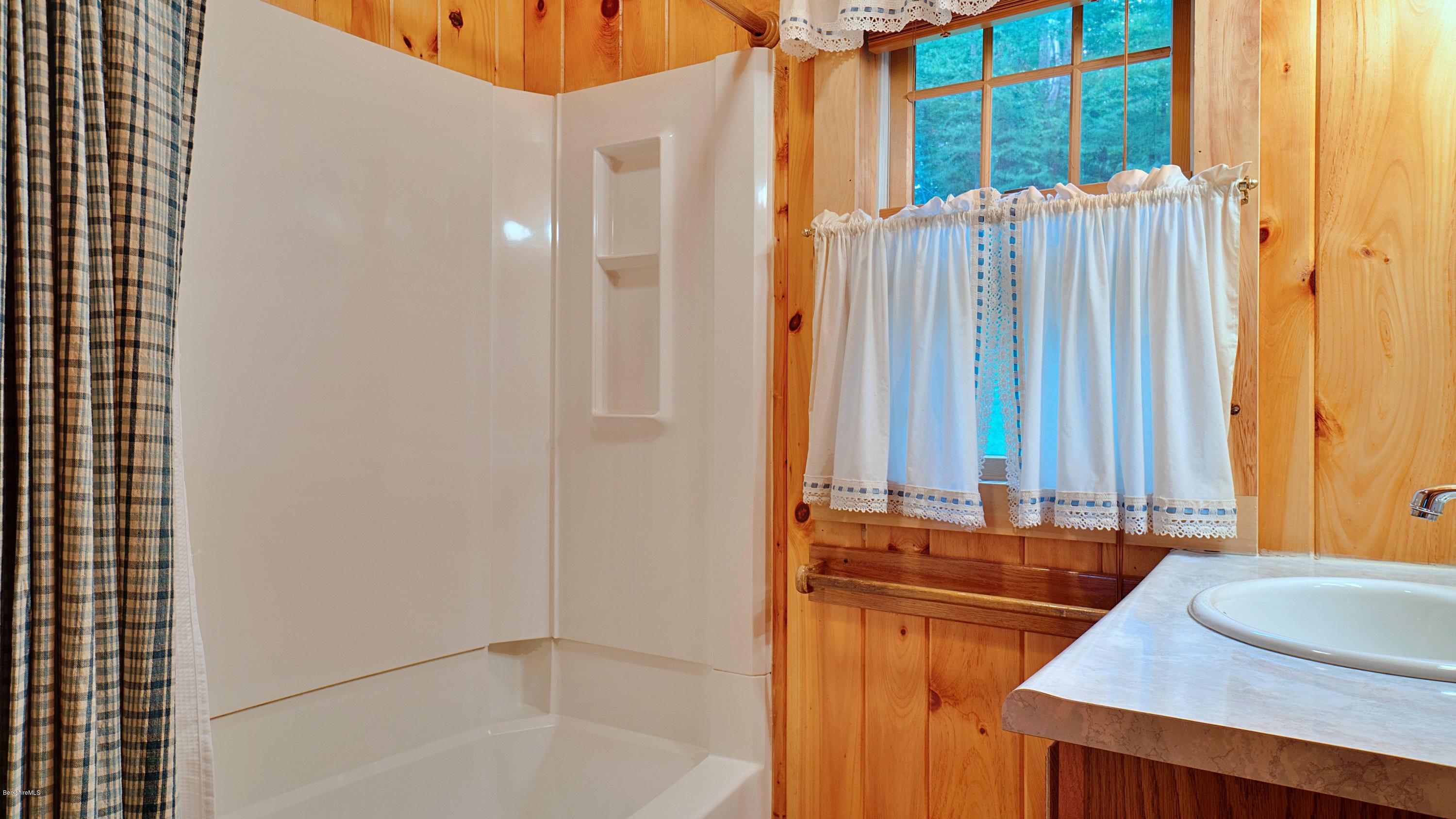18 Mahkeenac Heights Road Stockbridge, MA 01262 - Photo 14 of 19 a bathroom with a granite countertop sink and a mirror