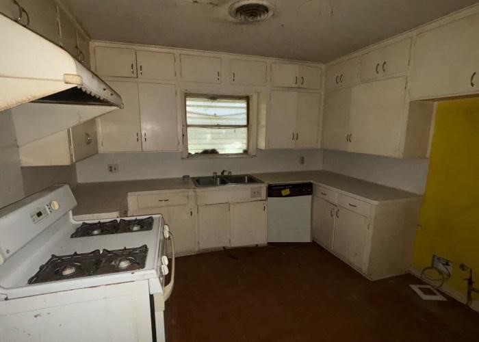 1301 Vauthier Street La Marque, TX 77568 - Photo 13 of 19 a kitchen with a sink stove and cabinets