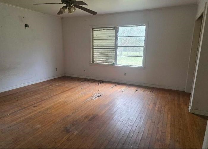 1301 Vauthier Street La Marque, TX 77568 - Photo 14 of 19 wooden floor in an empty room with a window