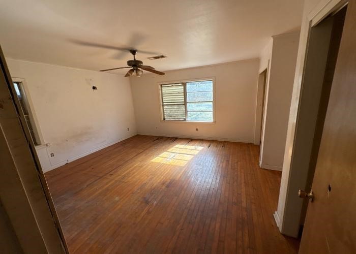 1301 Vauthier Street La Marque, TX 77568 - Photo 18 of 19 wooden floor in an empty room with a window