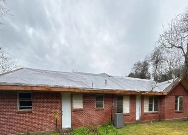 a view of a house with a sink and a yard