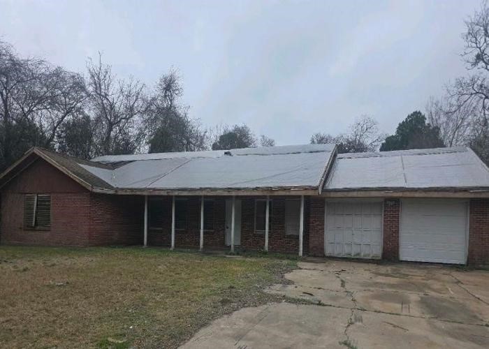 1301 Vauthier Street La Marque, TX 77568 - Photo 4 of 19 a front view of a house with a garden and tree