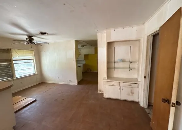 an empty room with windows and closet