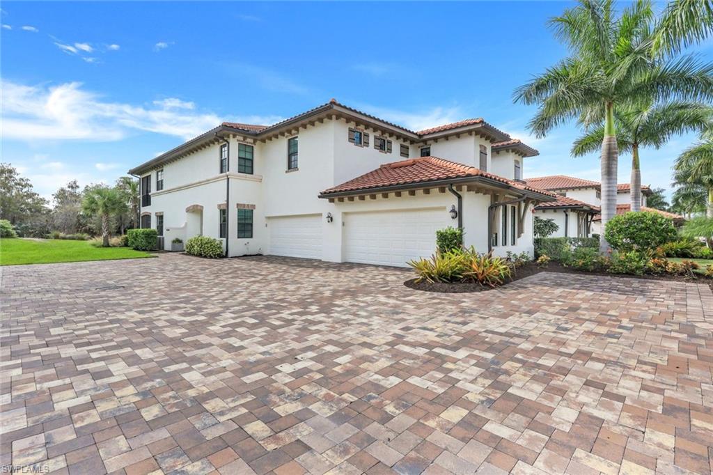 16348 Viansa Way, Unit 101 Naples, FL 34110 - Photo 19 of 34 a view of a house with a yard and potted plants