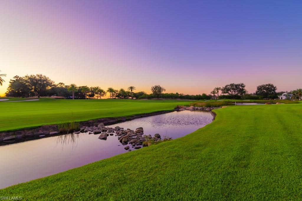 16348 Viansa Way, Unit 101 Naples, FL 34110 - Photo 32 of 34 a view of a lake with houses in the background