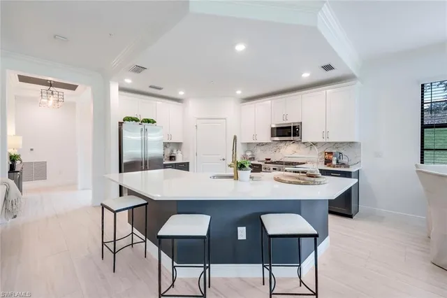 a view of kitchen with cabinets table and chairs