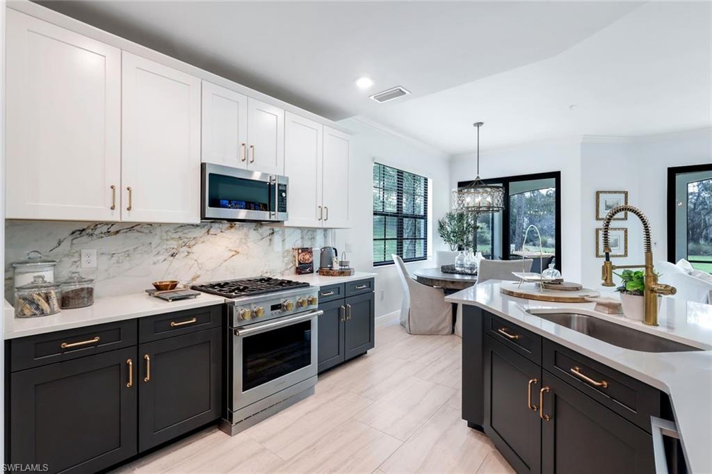 16348 Viansa Way, Unit 101 Naples, FL 34110 - Photo 9 of 34 a kitchen with a sink stove and cabinets