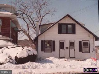 1427 New Holland Road Reading, PA 19607 - Photo 1 of 1 a front view of a house with a yard covered in snow