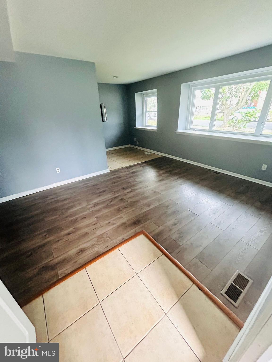 8131 Langdon Street Philadelphia, PA 19152 - Photo 2 of 14 an empty room with wooden floor and windows