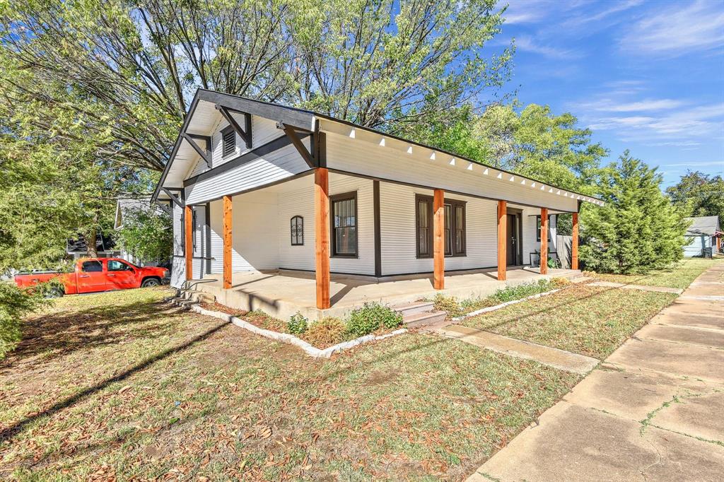 1115 South Rusk Avenue Denison, TX 75020 - Photo 1 of 21 a view of a white house with a yard and pathway