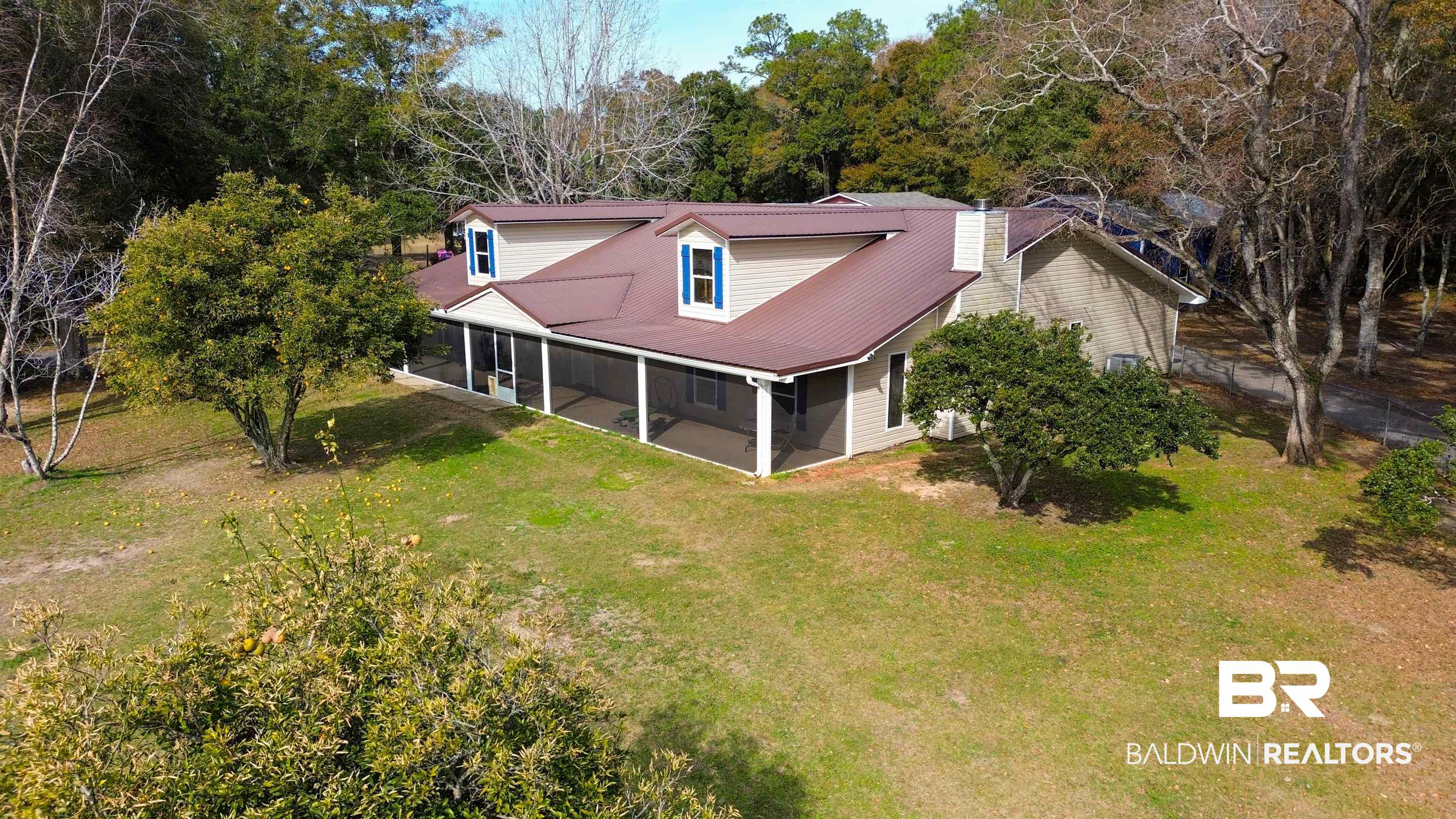 19365 Keller Road Foley, AL 36535 - Photo 39 of 41 Exterior space featuring a sunroom and a lawn