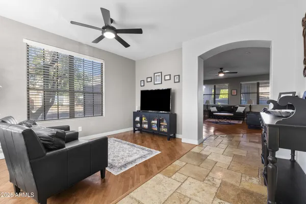 a living room with furniture and wooden floor
