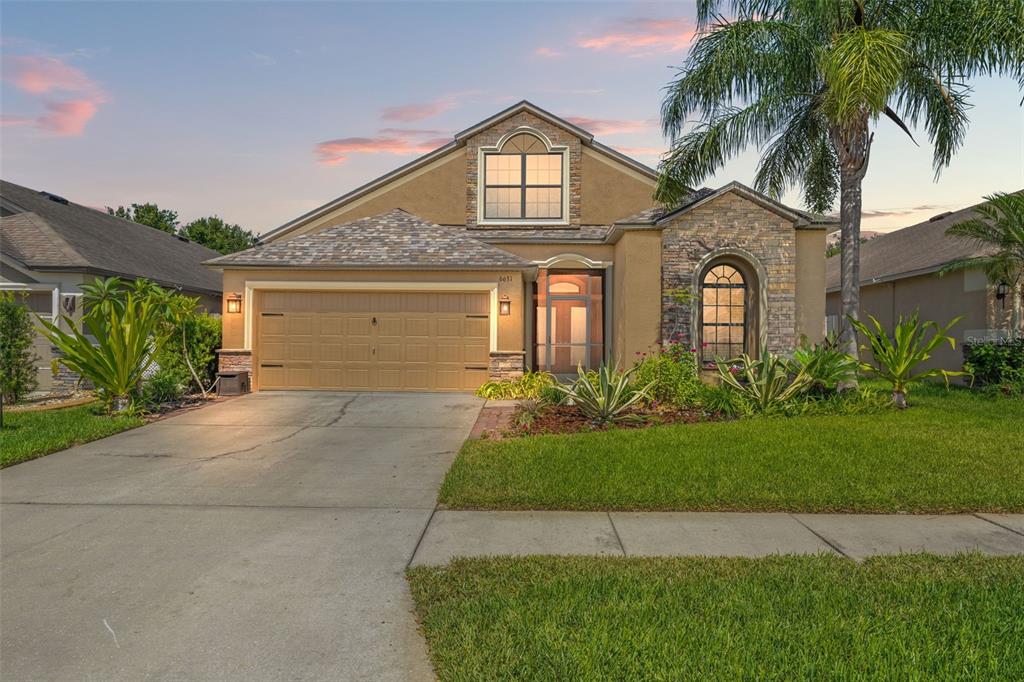6631 Boulder Run Loop Wesley Chapel, FL 33545 - Photo 1 of 1 a front view of a house with a yard