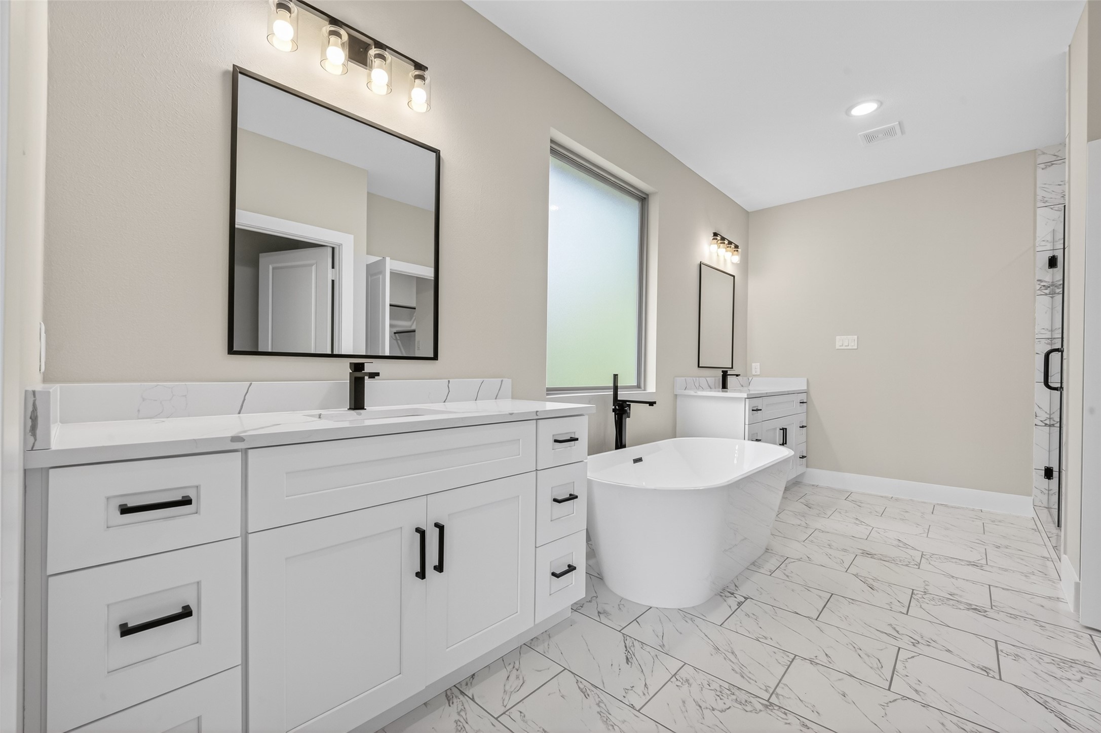 4902 Wunder Way Houston, TX 77069 - Photo 19 of 41 a bathroom with a double vanity sink mirror and bathtub