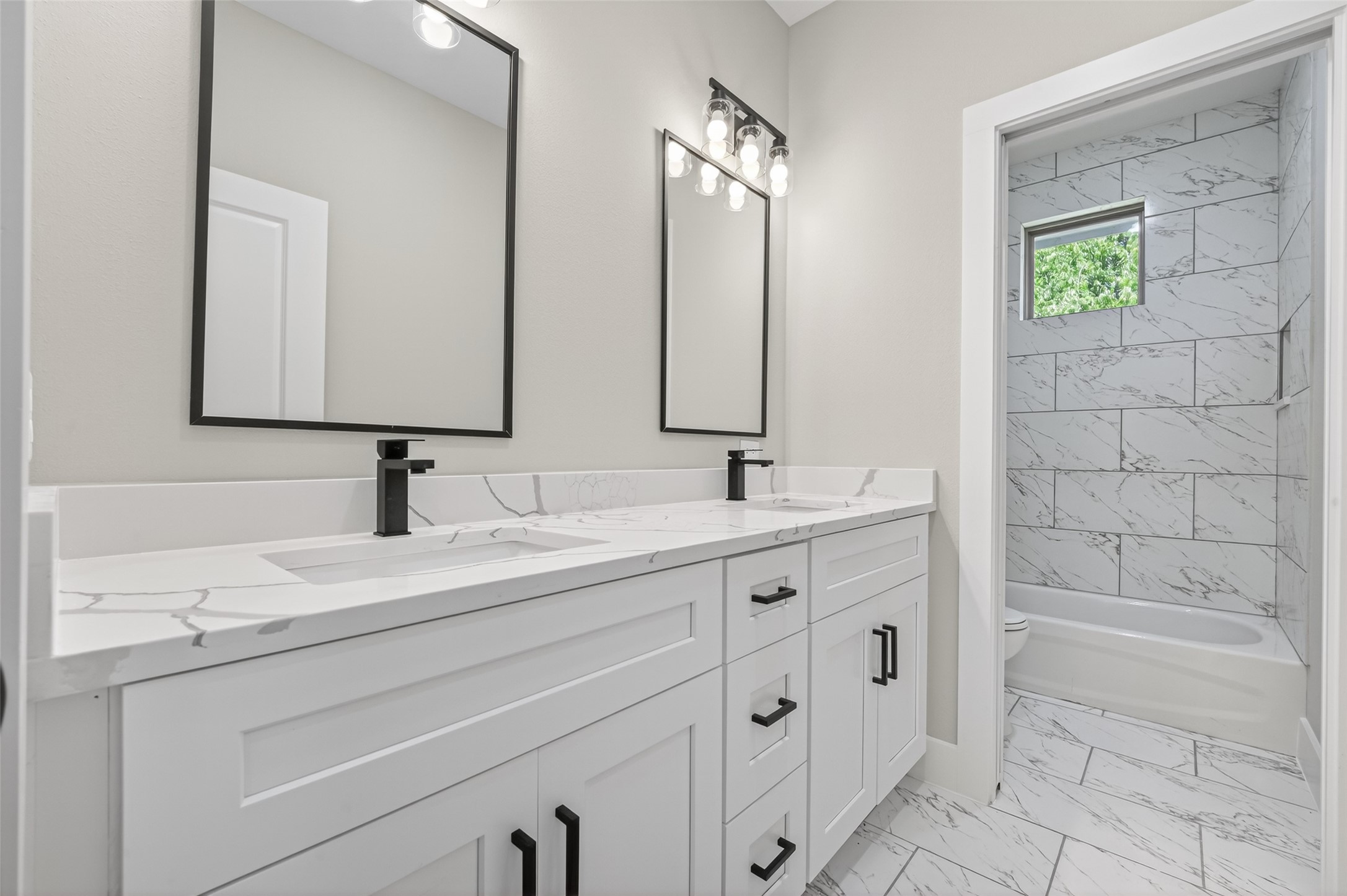 4902 Wunder Way Houston, TX 77069 - Photo 28 of 41 a bathroom with a sink double vanity and a bathtub