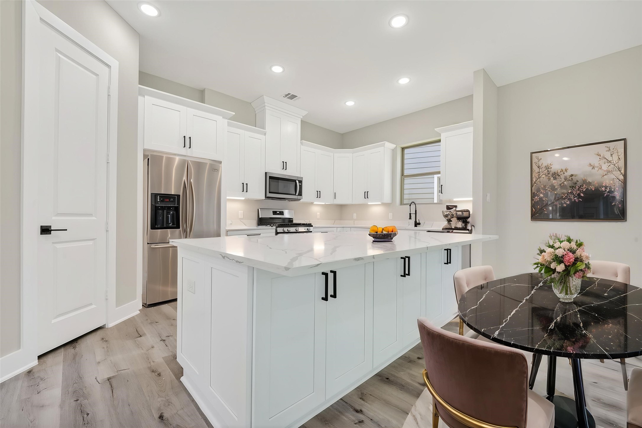 4902 Wunder Way Houston, TX 77069 - Photo 5 of 41 a kitchen with white cabinets and refrigerator