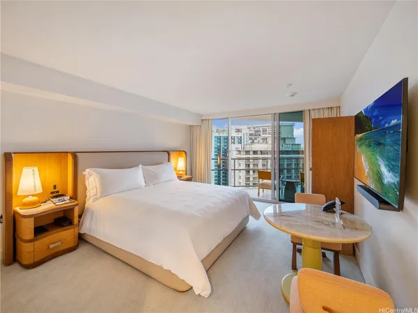 a bedroom with a bed and a flat screen tv