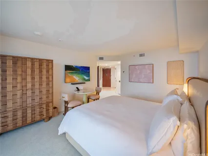 a bedroom with a bed and a lamp