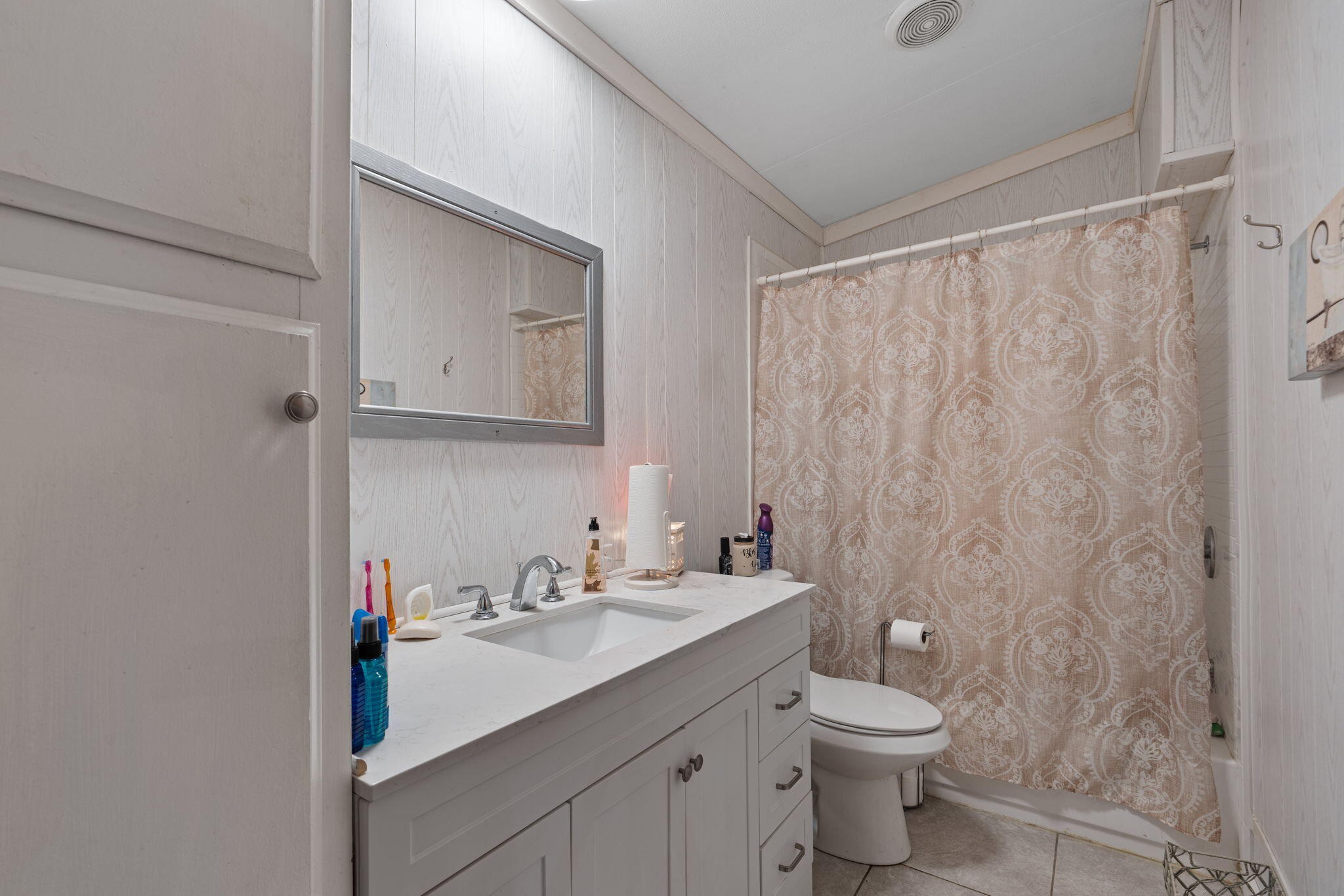 129 Farris Road Cleveland, TN 37323 - Photo 19 of 26 a bathroom with a granite countertop sink a toilet and a mirror