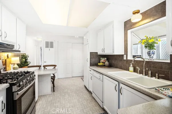 a kitchen with a sink stove and cabinets