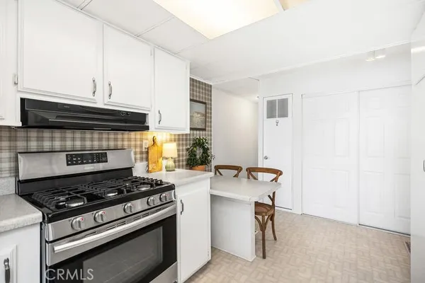a stove top oven sitting inside of a kitchen