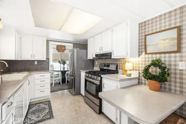 a kitchen with a stove a sink and a refrigerator