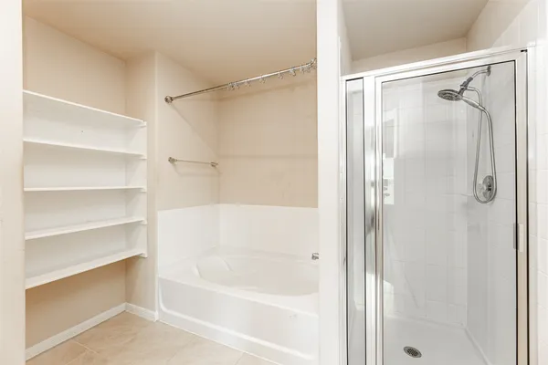 a bathroom with a shower and a bath tub