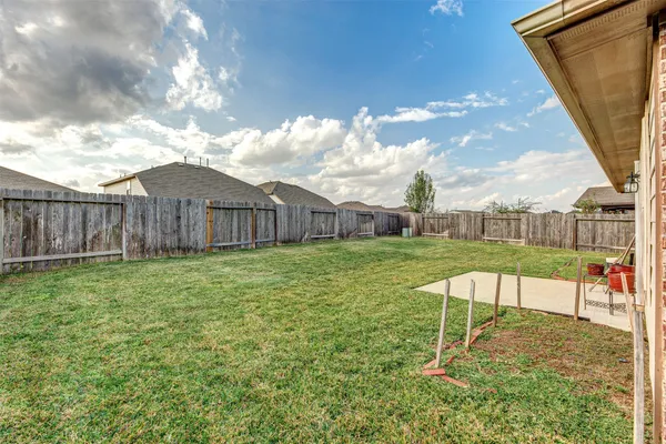 a front view of a house with a garden and yard