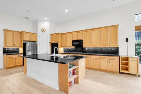 a kitchen with stainless steel appliances granite countertop a sink and cabinets