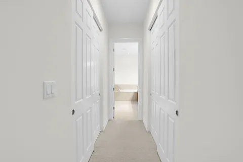 a view of a bathroom from a hallway