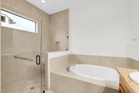 a bathroom with a tub and shower
