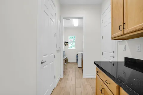 a kitchen with granite countertop a sink and cabinets