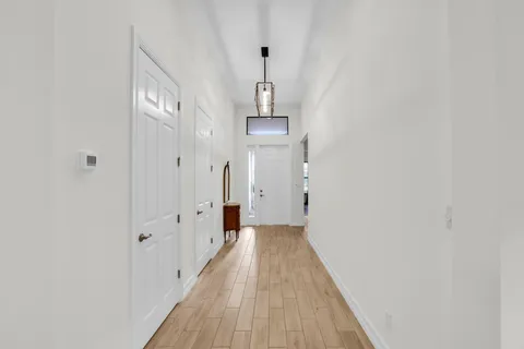 a view of a hallway with wooden floor