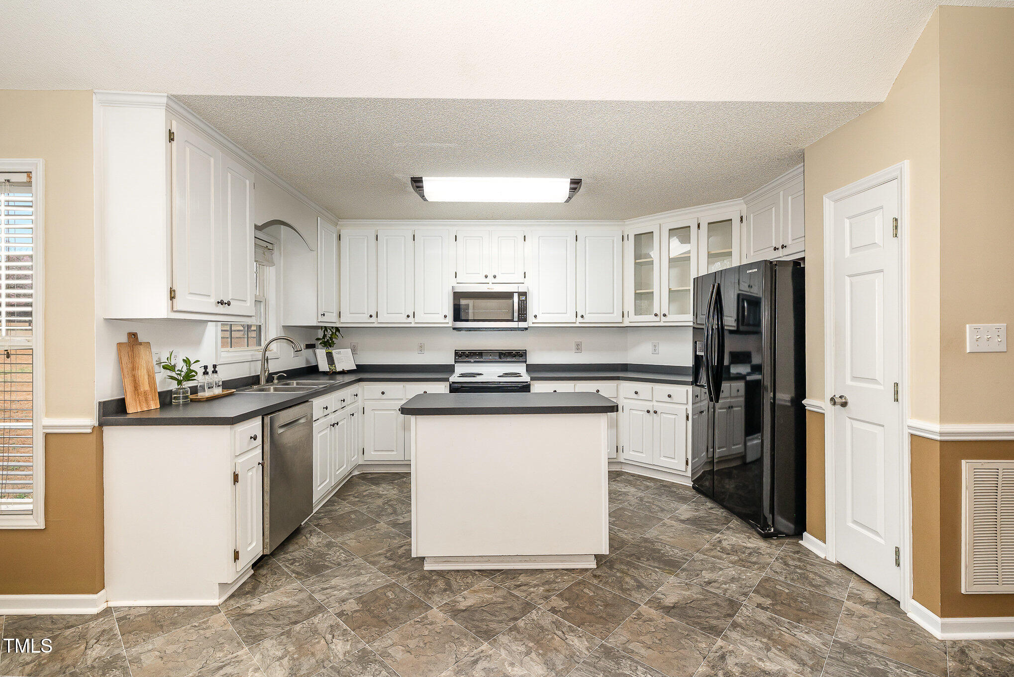 3733 Polenta Road Clayton, NC 27520 - Photo 8 of 51 a kitchen with stainless steel appliances granite countertop a refrigerator stove microwave and sink