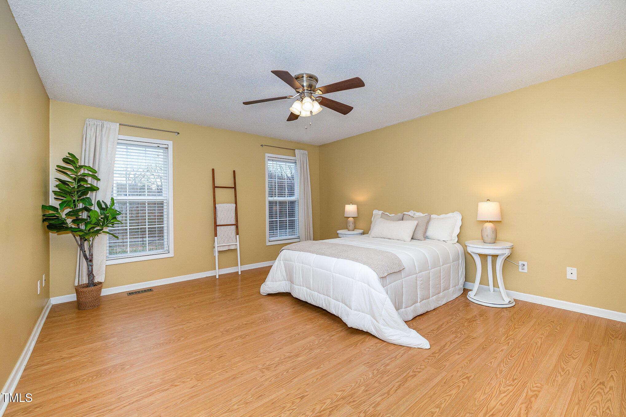 3733 Polenta Road Clayton, NC 27520 - Photo 9 of 51 a bedroom with a large bed and a chandelier