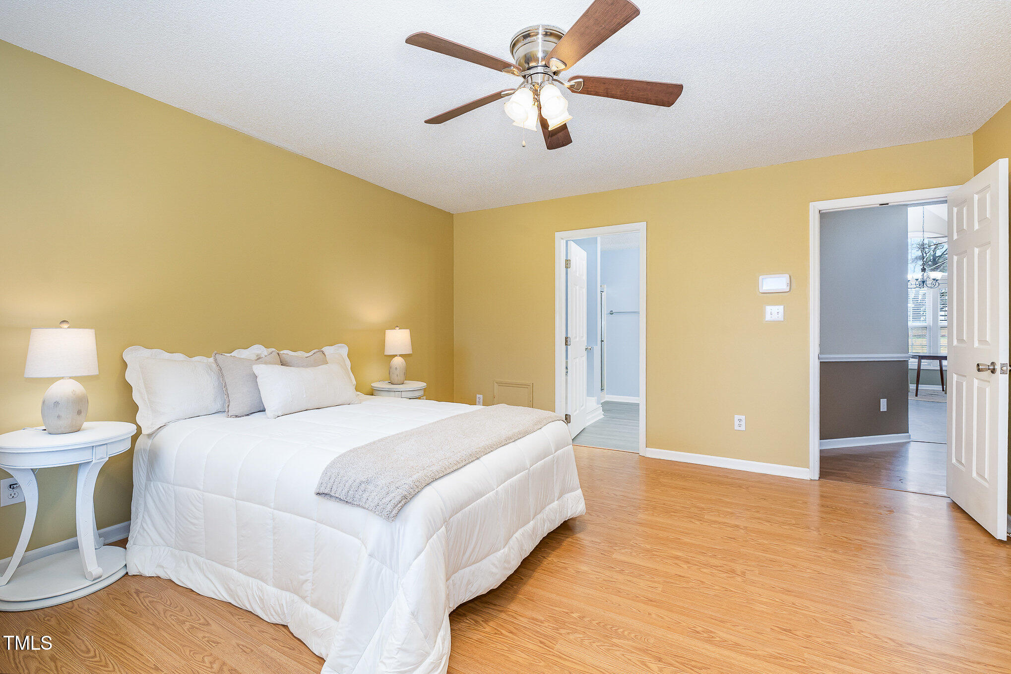 3733 Polenta Road Clayton, NC 27520 - Photo 10 of 51 a spacious bedroom with a bed and a chandelier