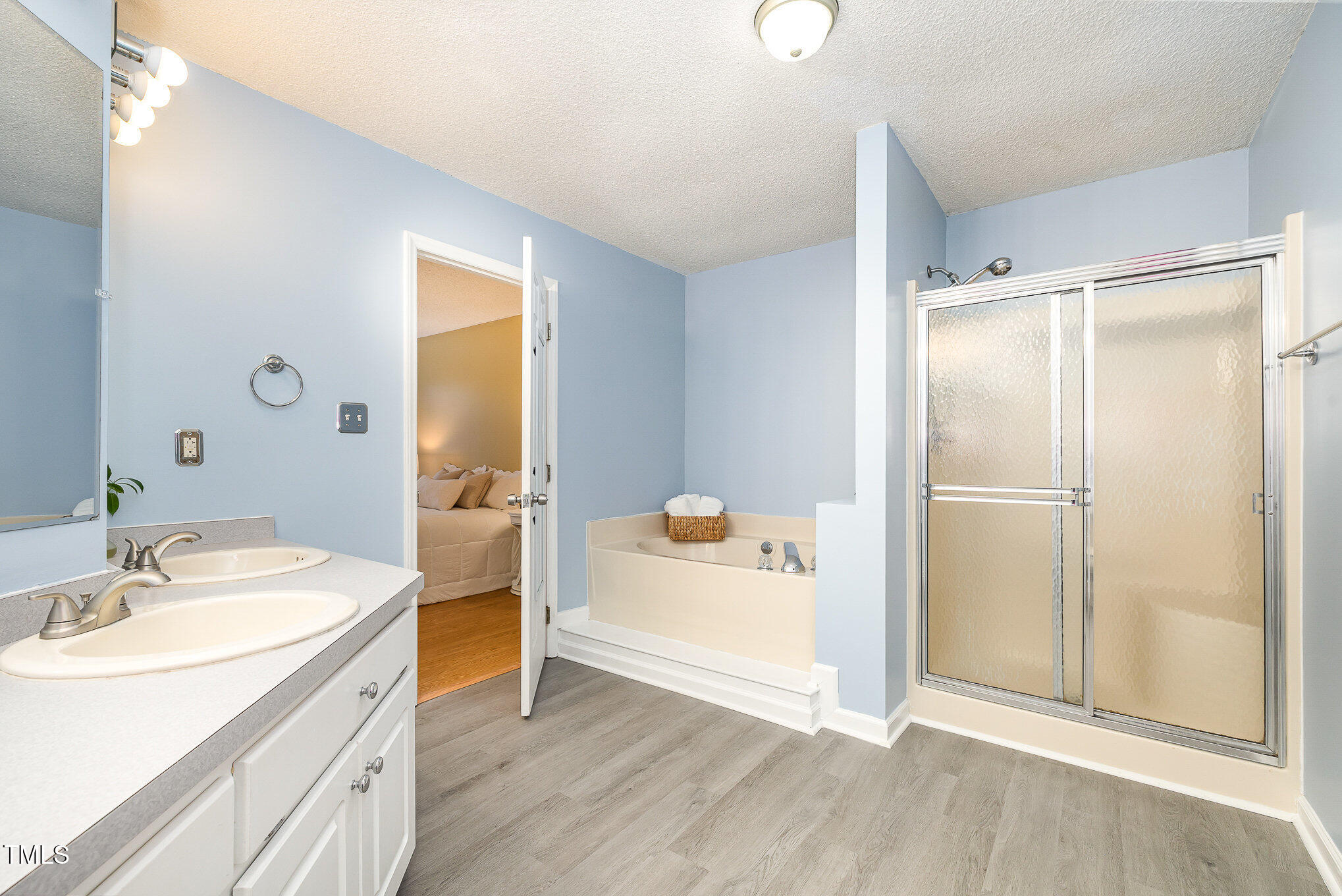 3733 Polenta Road Clayton, NC 27520 - Photo 13 of 51 a bathroom with a granite countertop sink a mirror and a bathtub